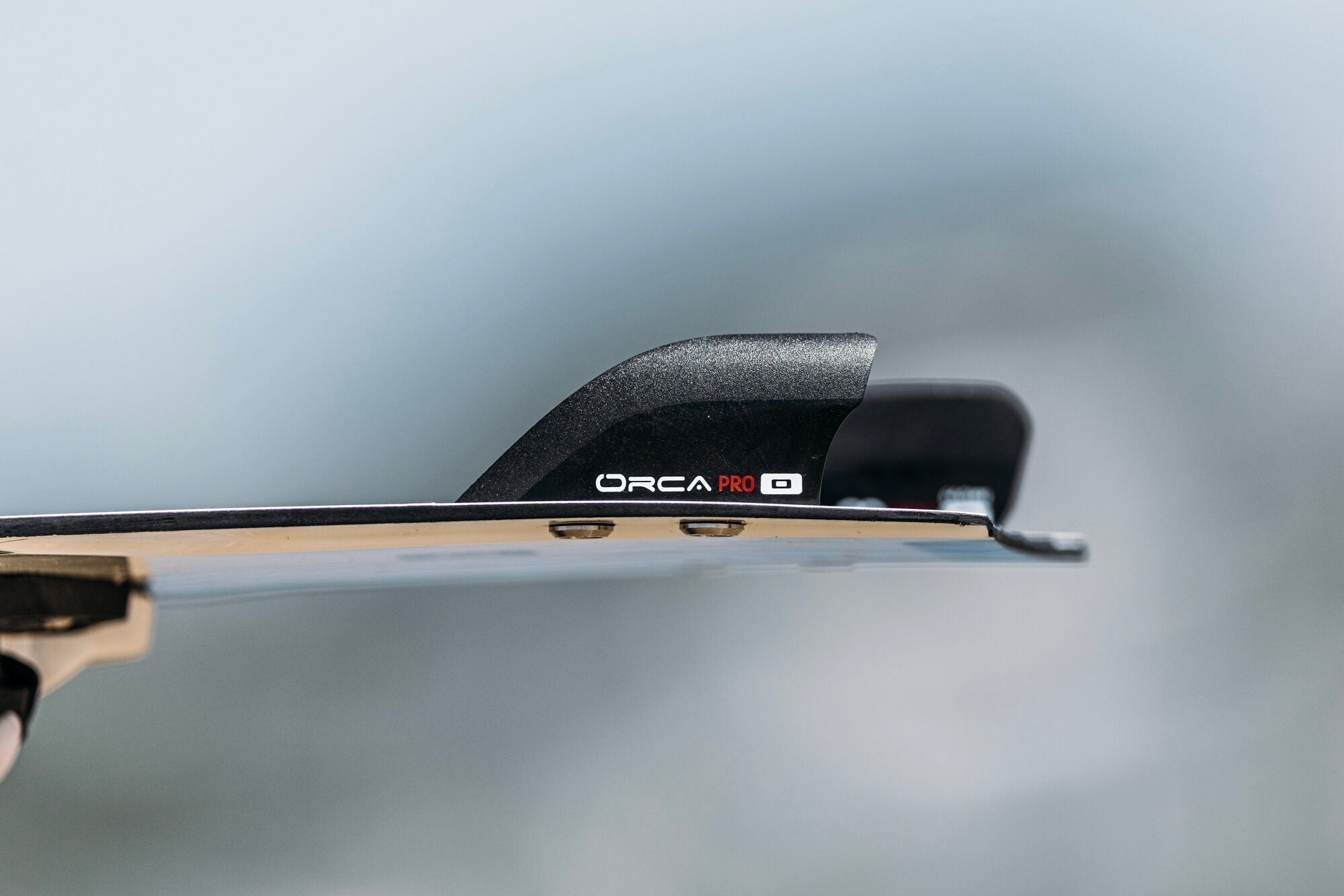 Close up of the Orca Pro big air kiteboardig fin mounted on a twin tip board